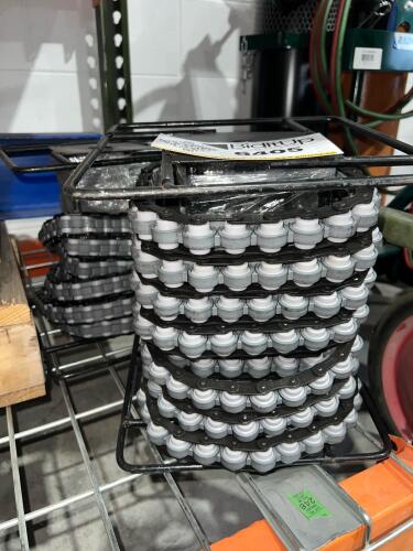 Assorted Plastic Modular Conveyor Chain Sections in Metal Storage Rack