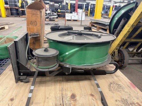 Signode Plastic Strapping Dispenser with (2) rolls of green polyester (PET) industrial strapping
