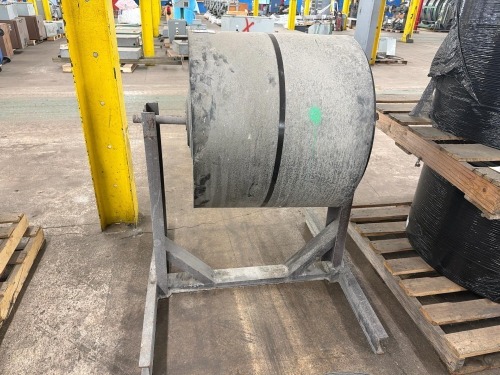 Heavy-duty conveyor belting mounted on a storage stand.