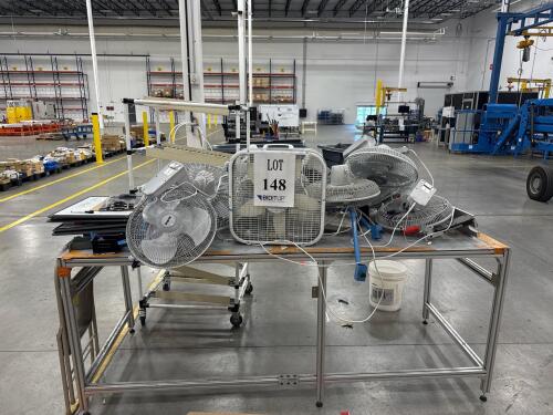 TABLE W/ ASSORTED FANS <br/>[LOCATION: GIGAFACTORY]