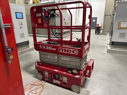 The MEC 1330SE Micro is a compact, electric scissor lift designed for tight indoor spaces, featuring a 13-foot platform height and a 19-foot working height. Its ultra-slim design, with a chassis width of only 30 inches, allows it to fit through standard d