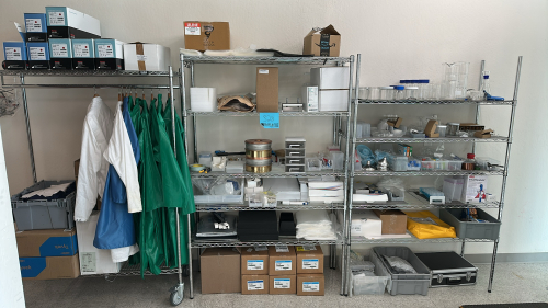 LOT OF (3) RACKS OF ASSORTED LABORATORY EQUIPMEMT, TO INCLUDE: SAFETY GLASSES, COTTON TIPPED APPLICATORS, LAB COATS, ASSORTED BEAKERS, ETC.