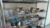 LOT OF (3) RACKS OF ASSORTED LABORATORY EQUIPMEMT, TO INCLUDE: SAFETY GLASSES, COTTON TIPPED APPLICATORS, LAB COATS, ASSORTED BEAKERS, ETC. - 3
