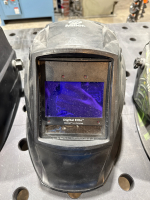 LOT OF (4) ASSTS WELDING HELMETS: MILLER QTOSZ87W3/8-13, MILLER DIGITAL ELITE OTOSZ87W3/8-13, MILLER CLASSICAL SERIES & KLUTCH: #48750/48751 & (1) WELDING GOGGLES MODEL:LY-100R - 4