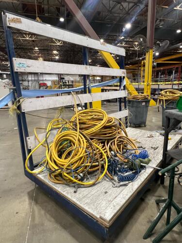 Assorted air compressor hoses on industrial rolling rack