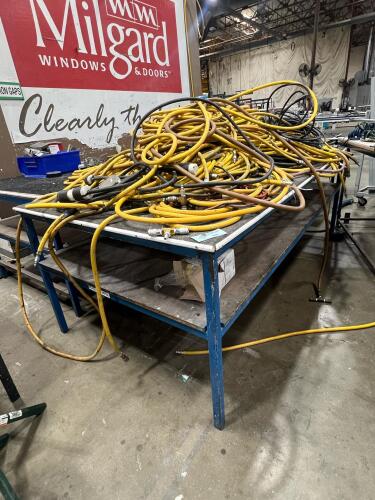 Assorted air compressor hoses and industrial table